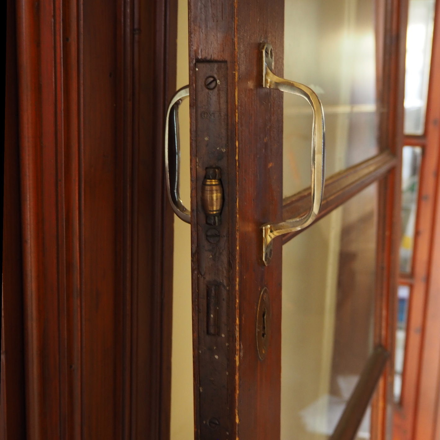 Solid varnished wooden door with glass panels
