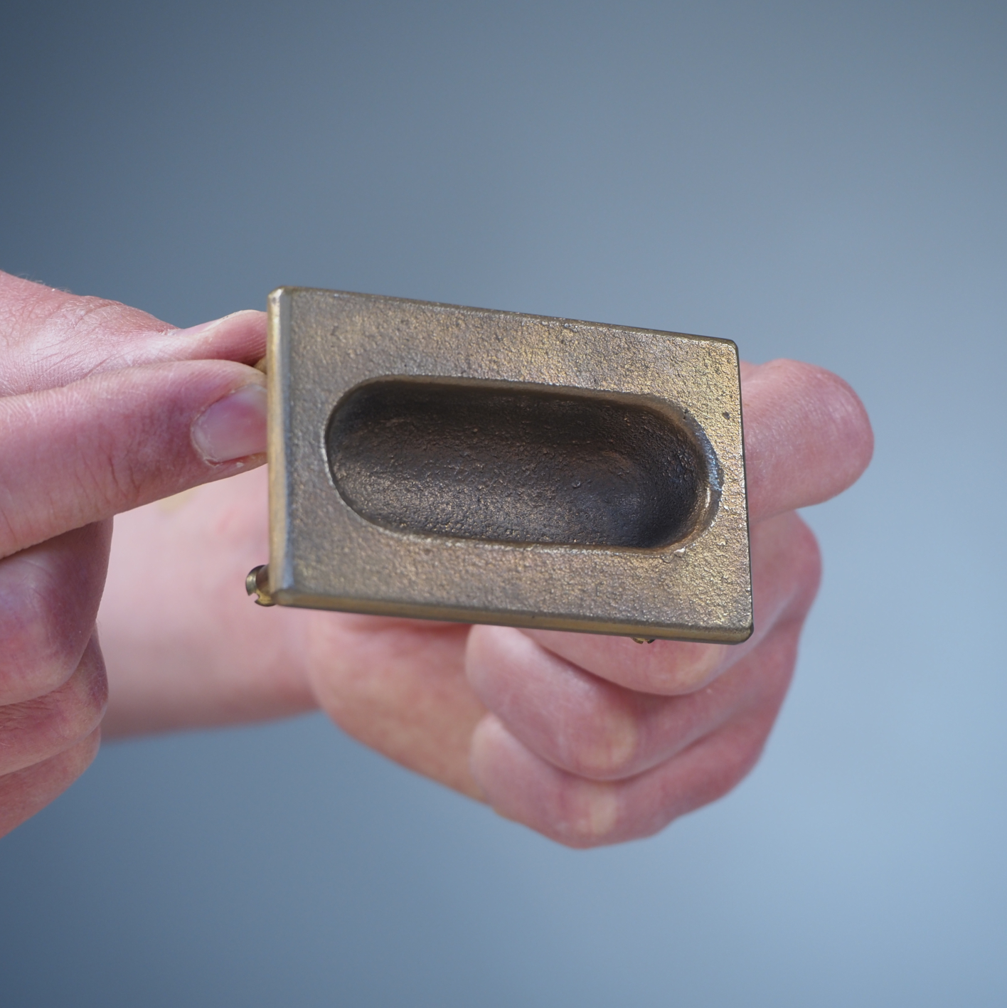 Small inset cabinet handle in solid bronze by Jules Wabbes