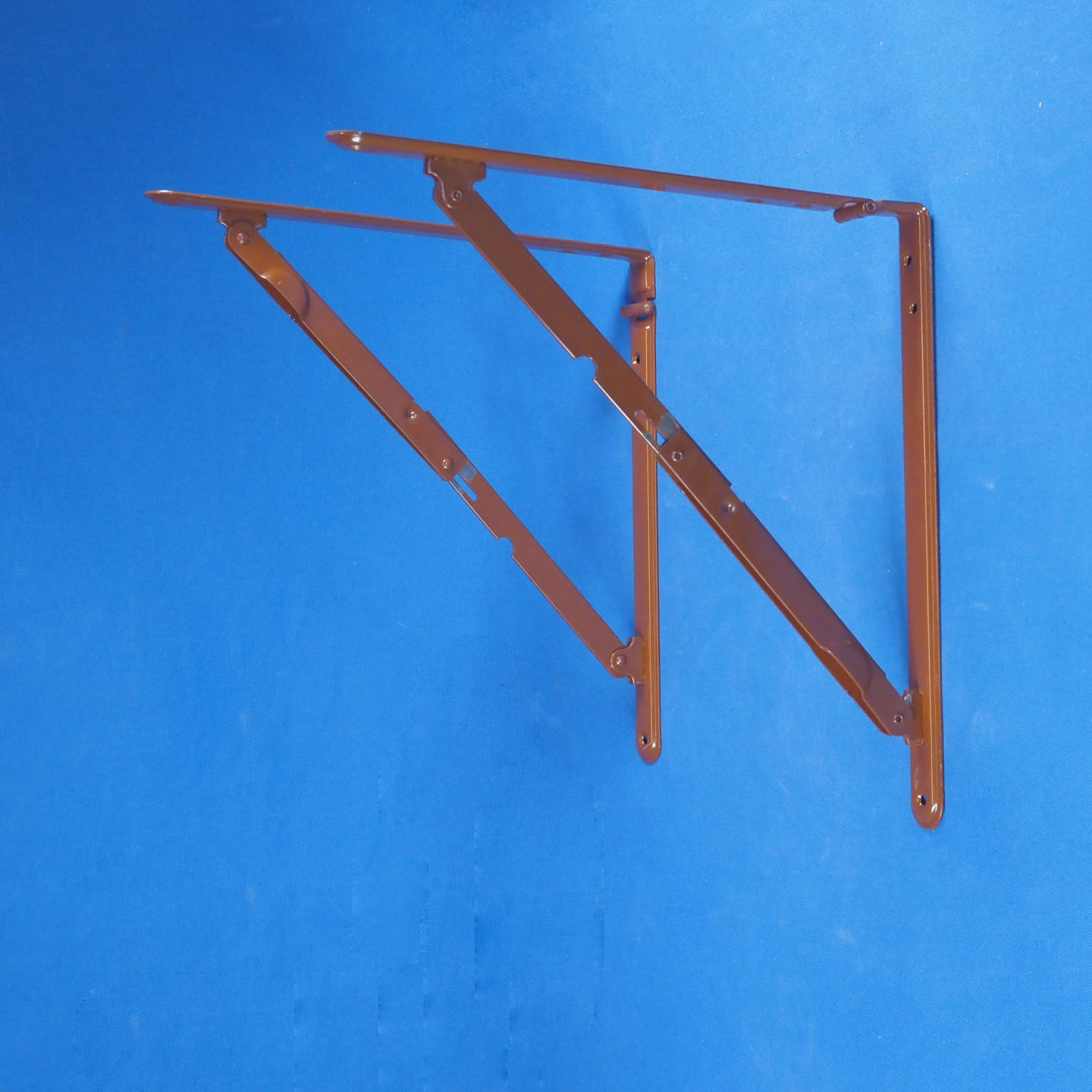 Pair of folding shelf brackets in brown powder coated steel.