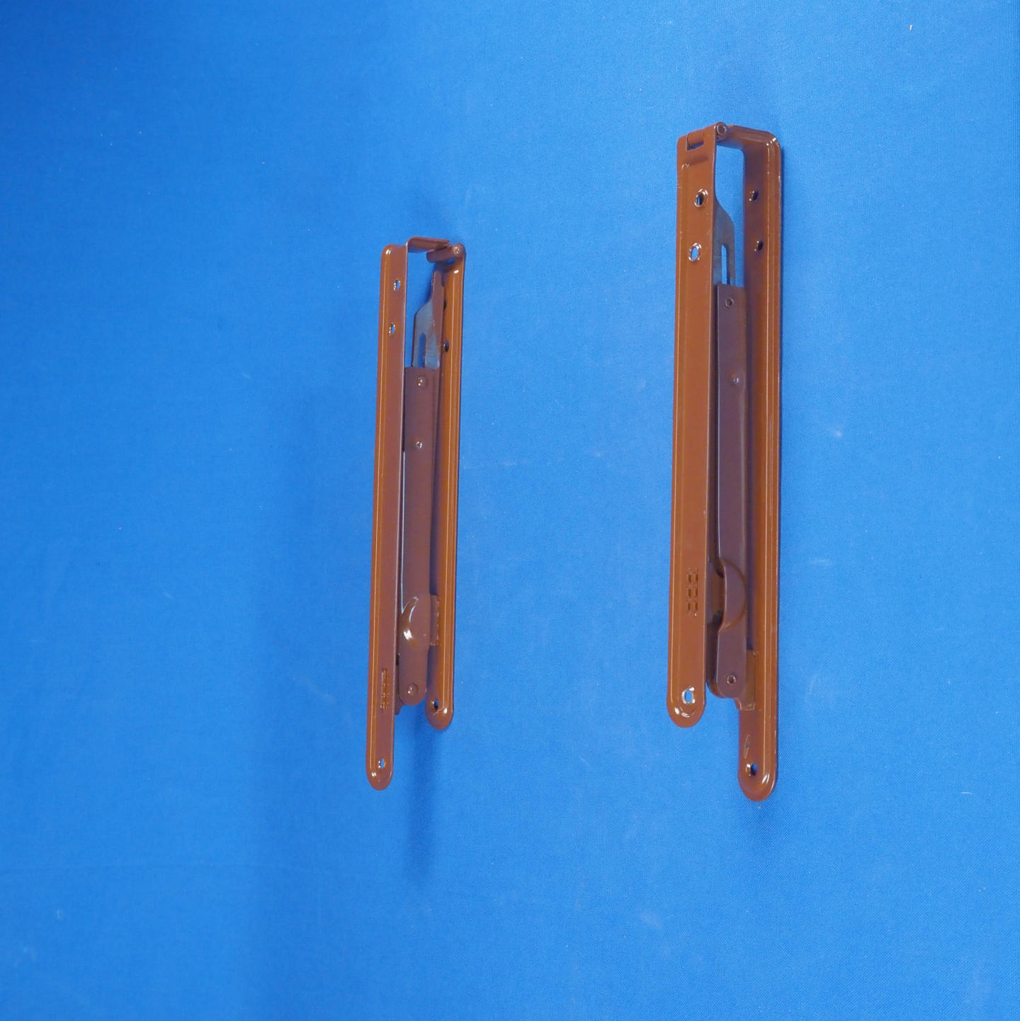 Pair of folding shelf brackets in brown powder coated steel.