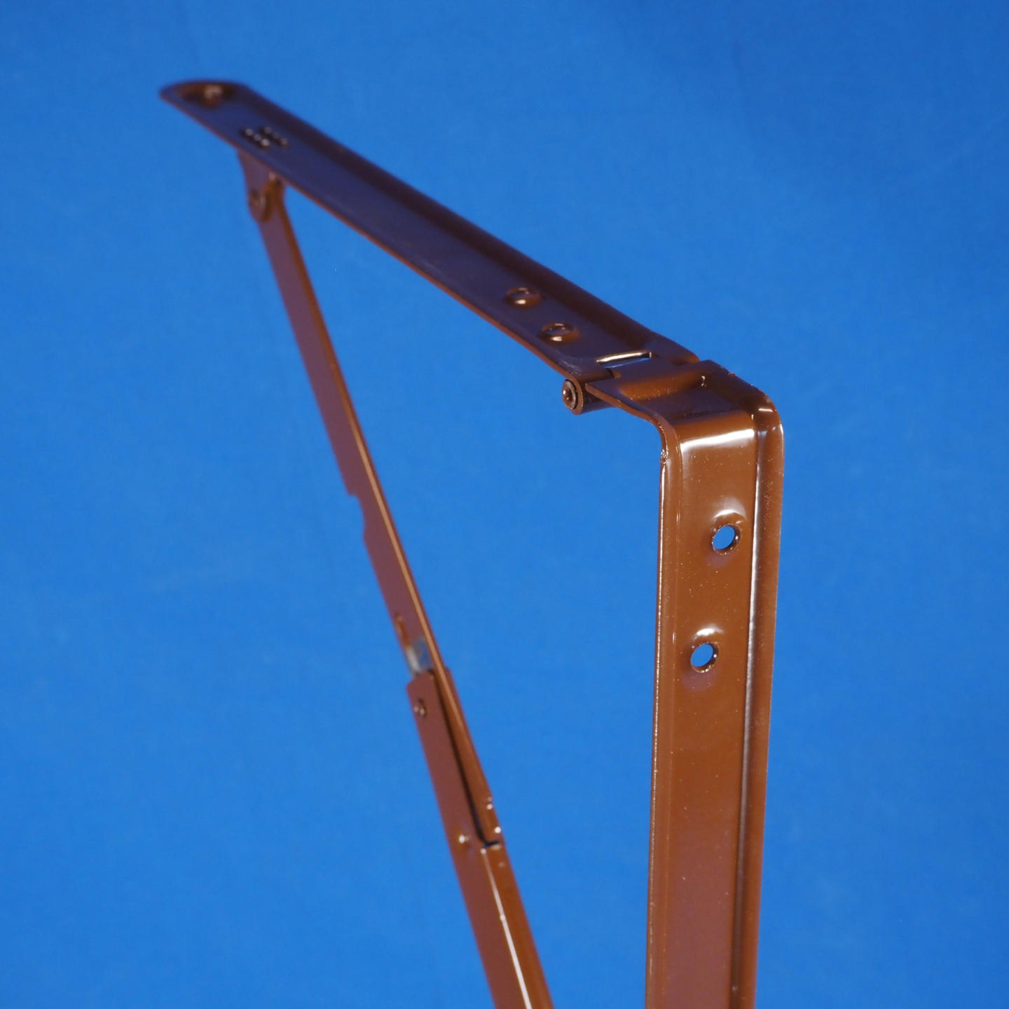 Pair of folding shelf brackets in brown powder coated steel.