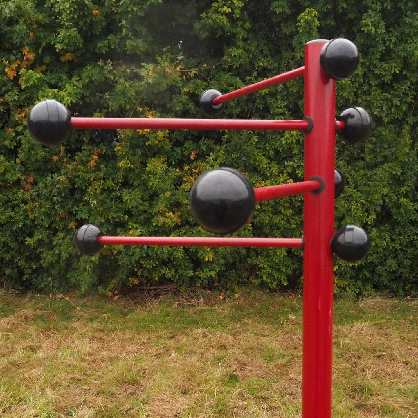 Coat rack in red coated bent steel