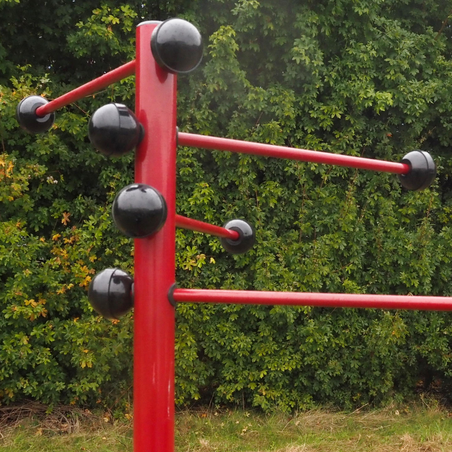 Coat rack in red coated bent steel