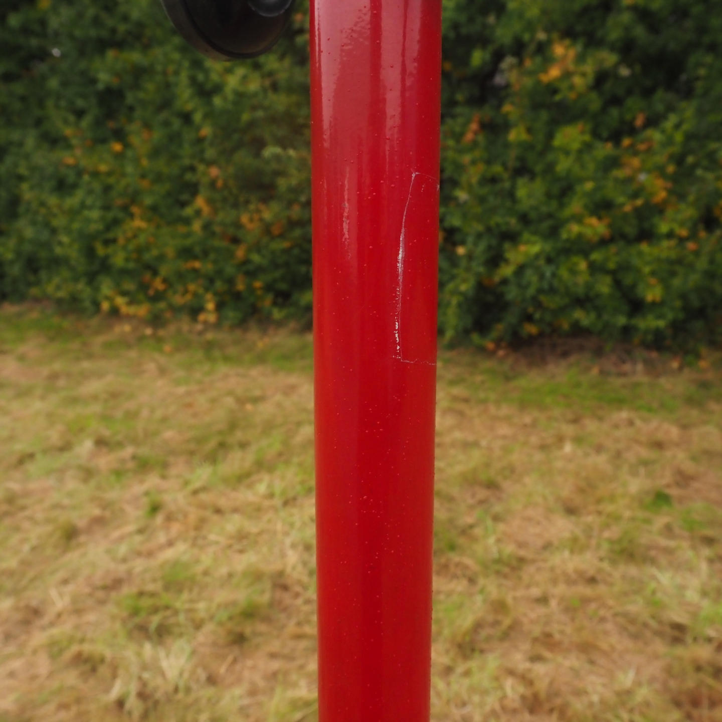 Coat rack in red coated bent steel