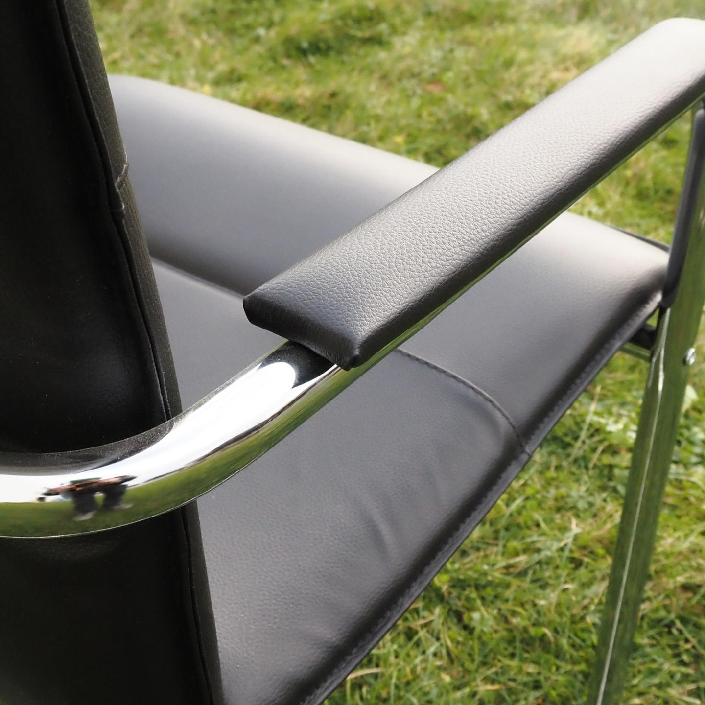 Cantilever armchair in steel and black synthetic leather