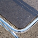 Coffee table with smoked tempered glass top and tubular chromed steel base