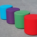 Round ottoman upholstered in various colorful fabric