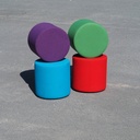 Round ottoman upholstered in various colorful fabric