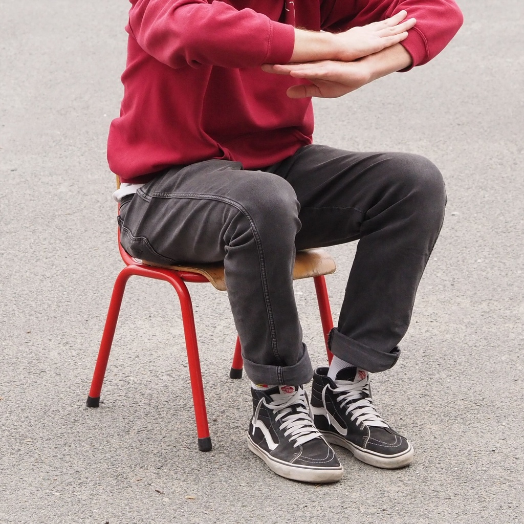 Stackable school chair with red tubular steel legs