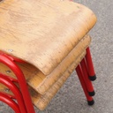 Stackable school chair with red tubular steel legs