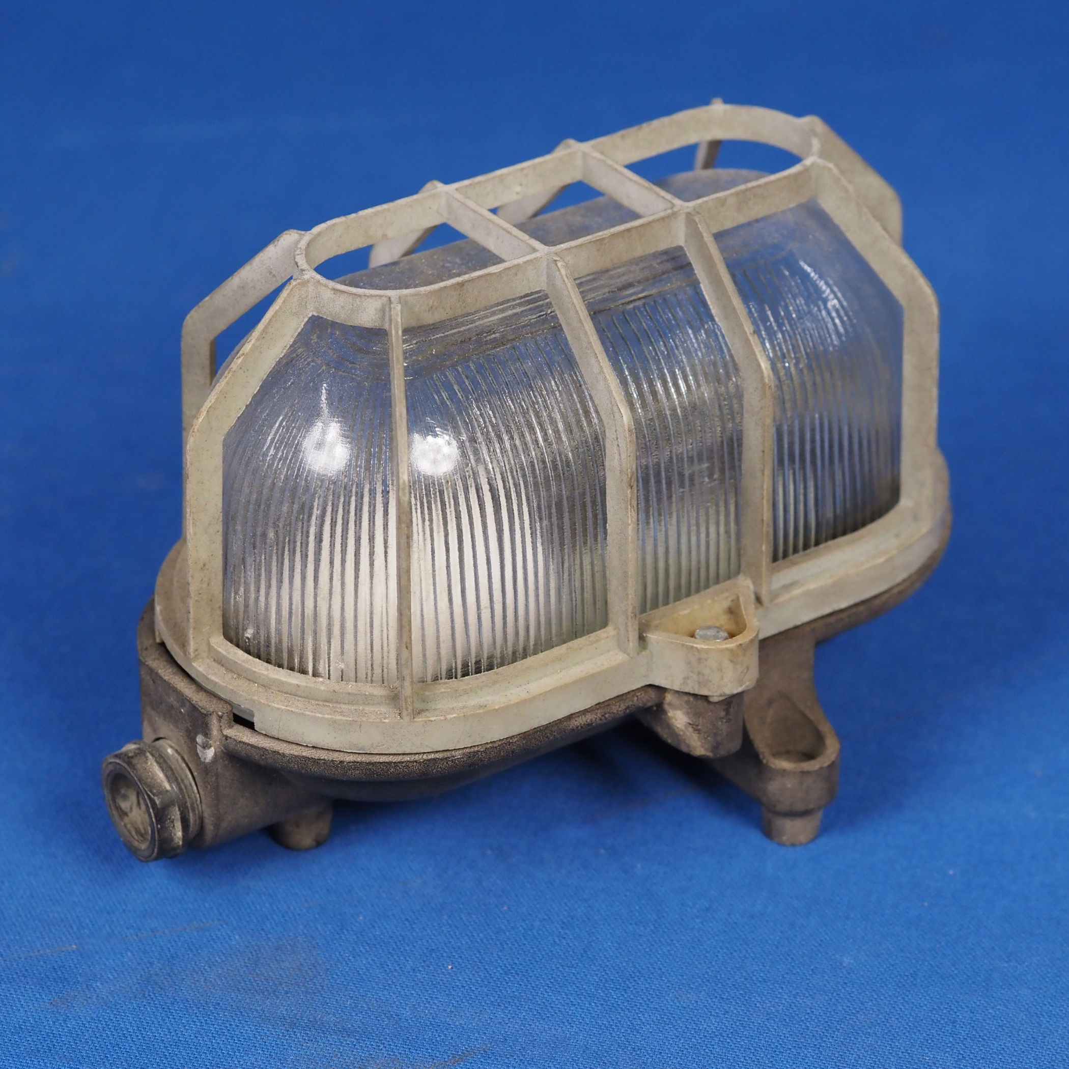 Caged wall/ceiling light with bakelite base and textured glass diffuser