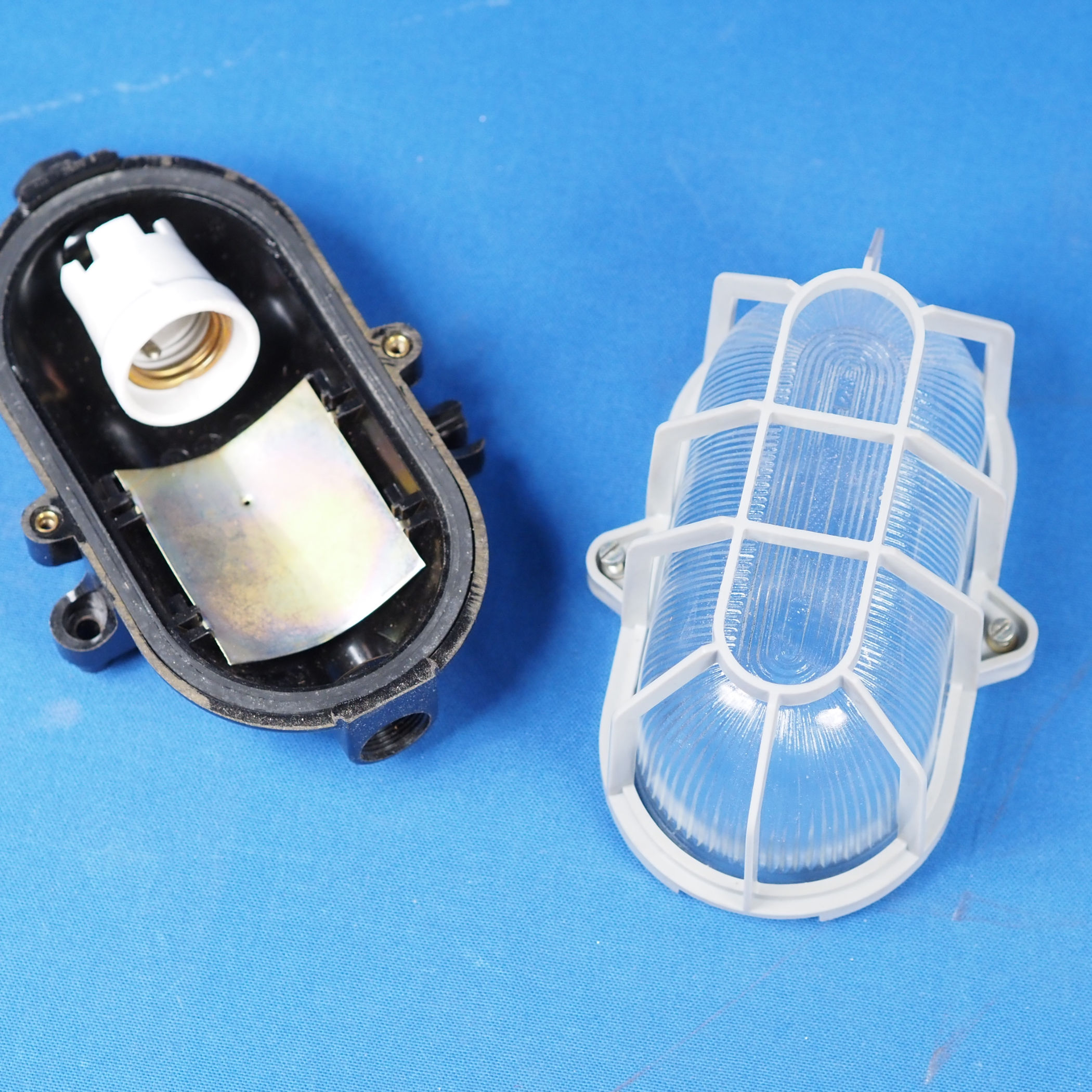 Caged wall/ceiling light with bakelite base and textured glass diffuser