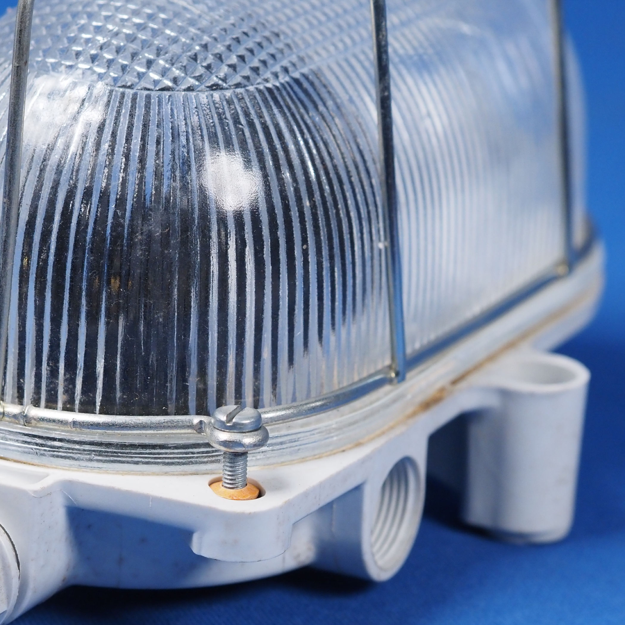 Caged wall/ceiling light with bakelite base, steel cage and textured glass diffuser by L'ébènoïd (E27)