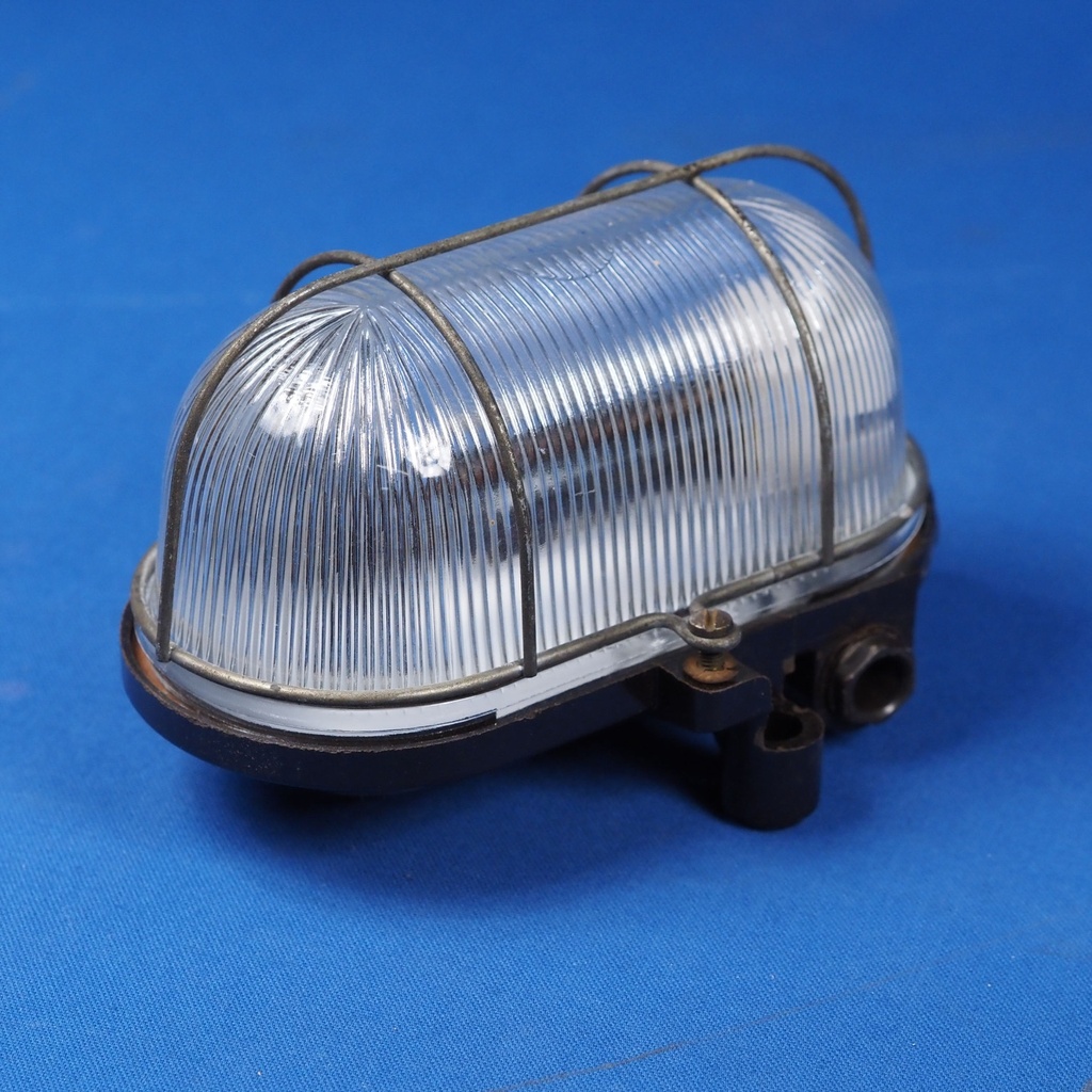 Caged wall/ceiling light with bakelite base, steel cage and textured glass diffuser