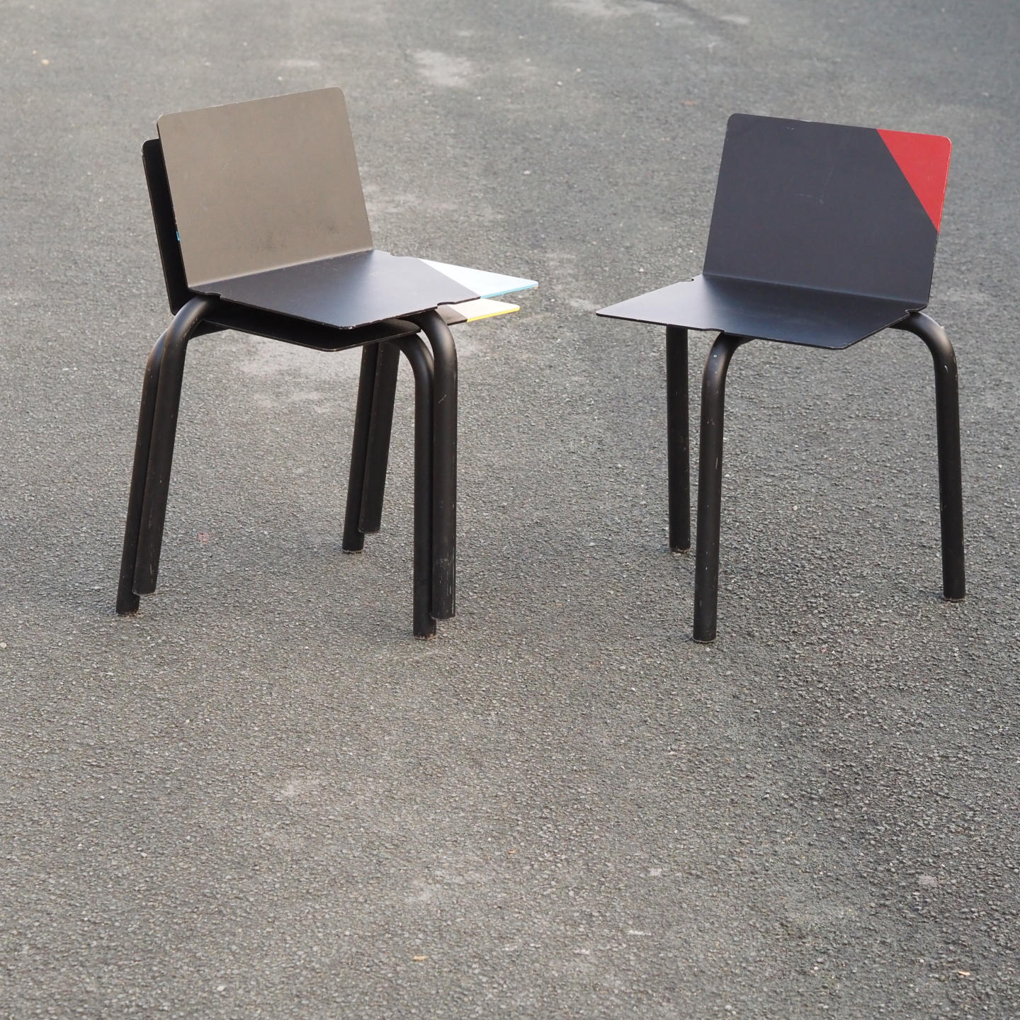 Black stackable chair by Pierre-Emmanuel Vandeputte (with various coloured corners)