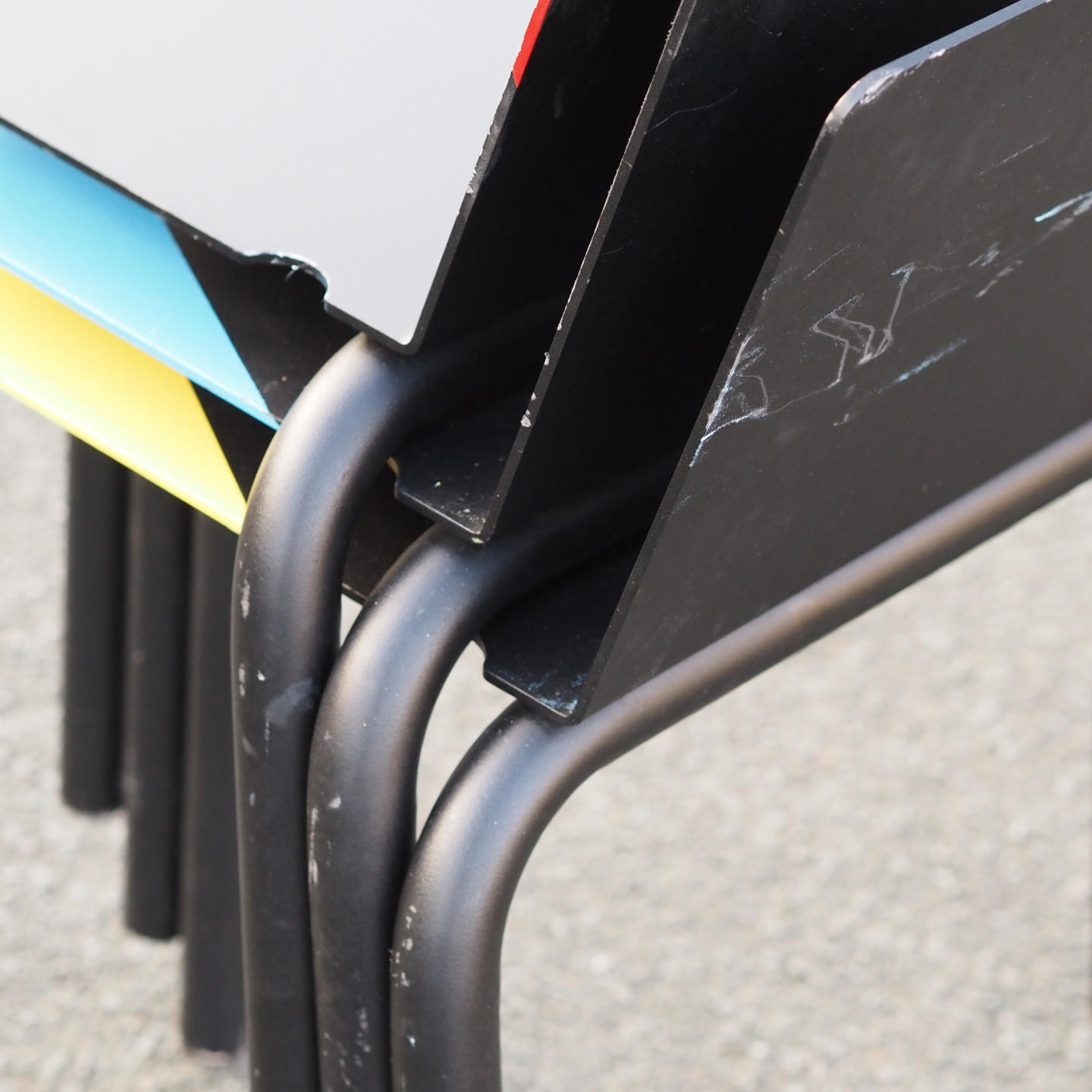 Black stackable chair by Pierre-Emmanuel Vandeputte (with various coloured corners)