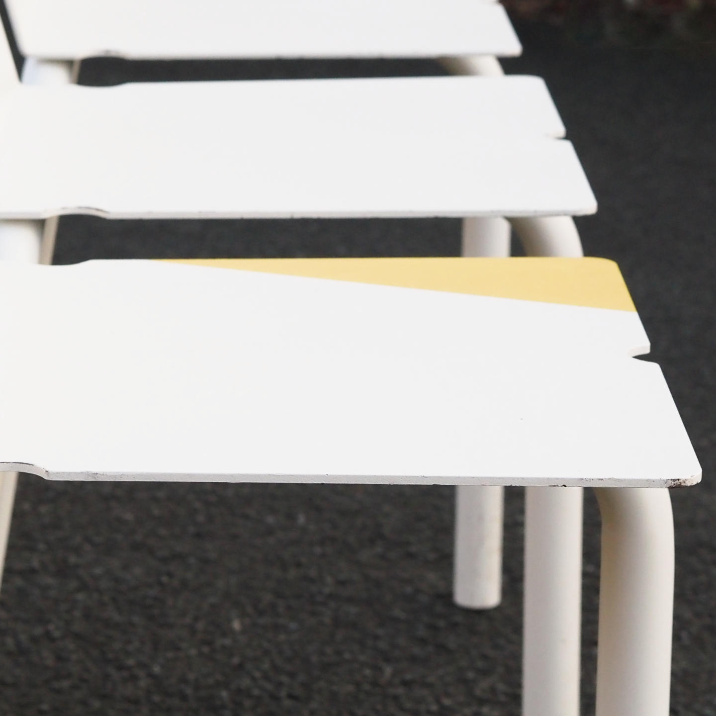 White stackable chair by Pierre-Emmanuel Vandeputte (with various coloured corners)