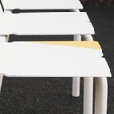 White stackable chair by Pierre-Emmanuel Vandeputte (with various coloured corners)