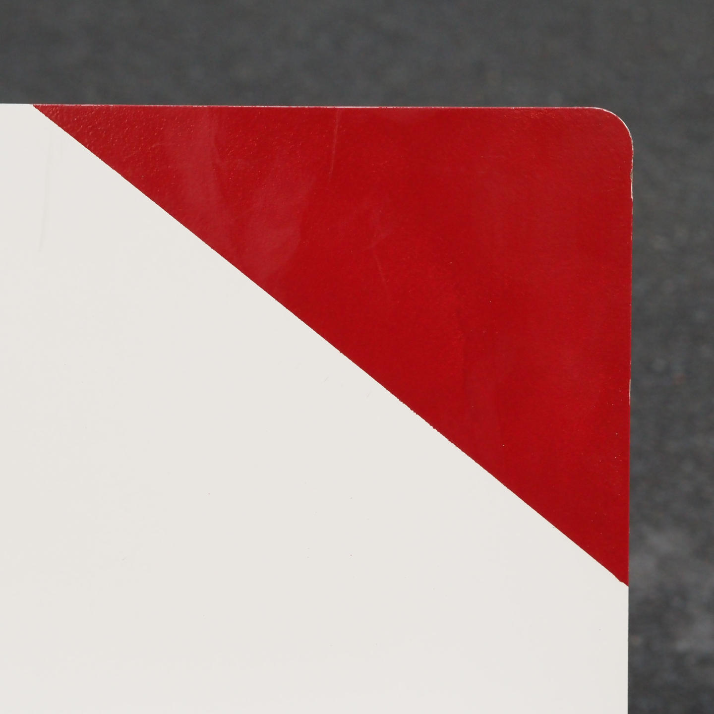 White stackable chair by Pierre-Emmanuel Vandeputte (with various coloured corners)