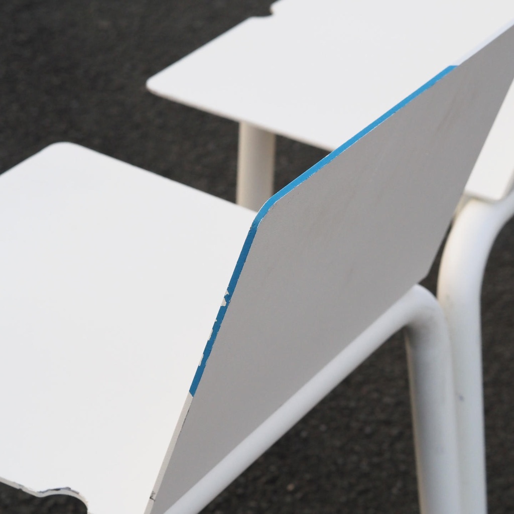 White stackable chair by Pierre-Emmanuel Vandeputte (with various coloured corners)