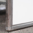 Corner reception desk with stainless steel frame and white laminate panels