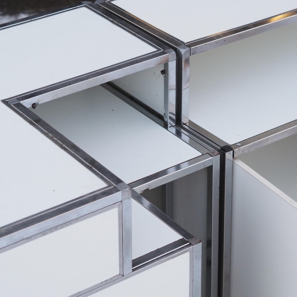 Corner reception desk with stainless steel frame and white laminate panels