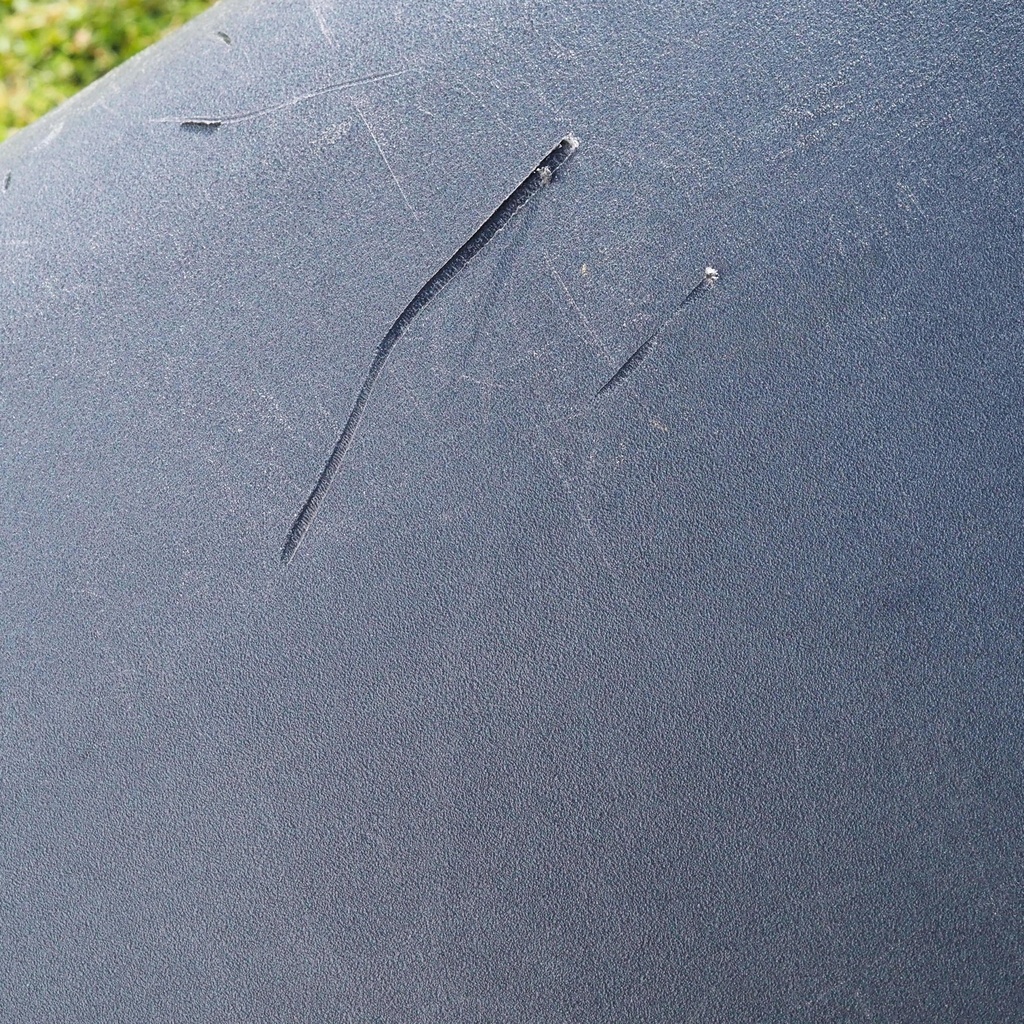 Round ottoman upholstered in various colorful fabric