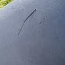 Round ottoman upholstered in various colorful fabric