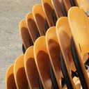 Stackable chair in varnished beech plywood and powder coated steel
