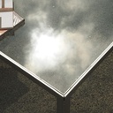 Coffee table in chromed steel with smoked glass tabletop and rotating tablets