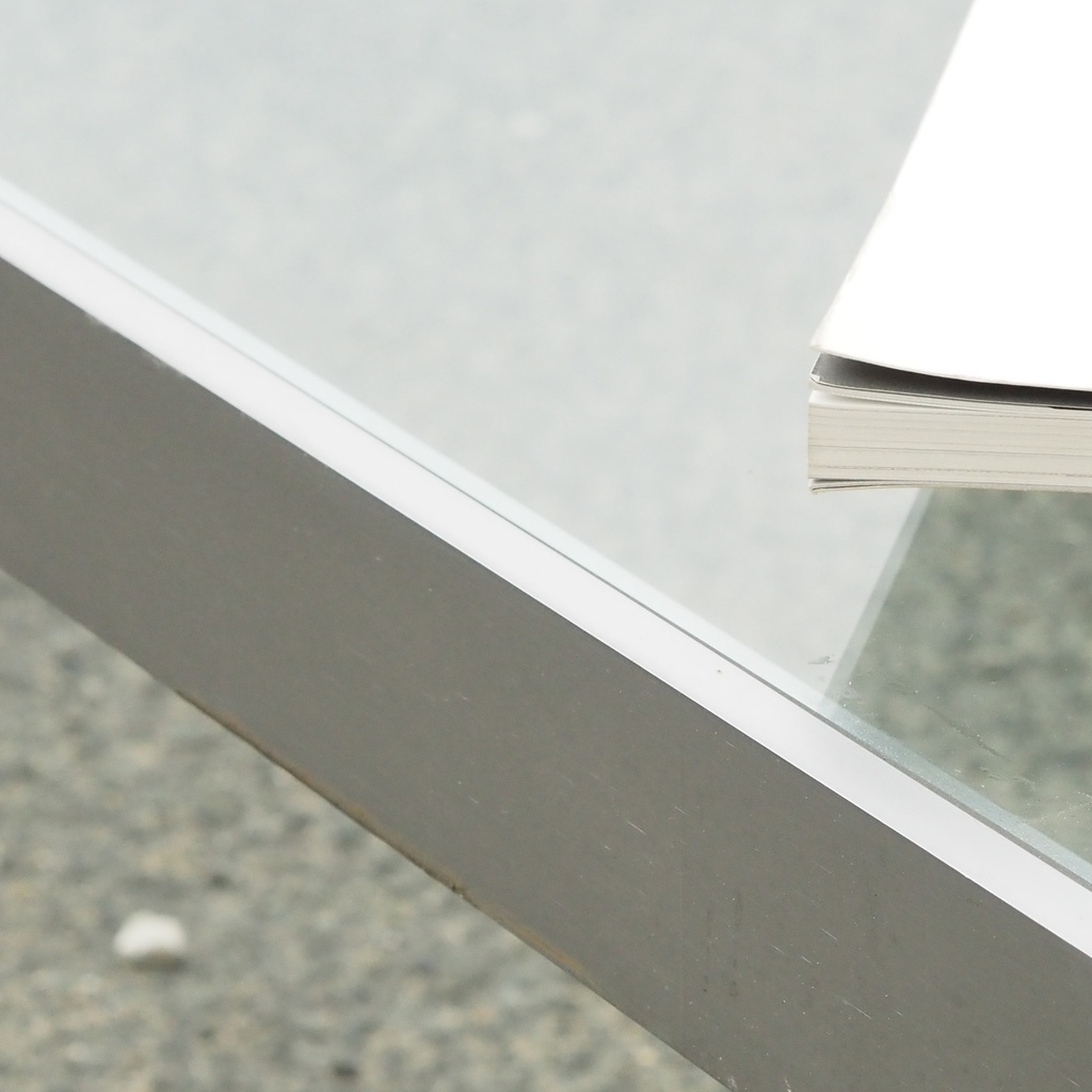 Coffee table in chromed steel with smoked glass tabletop and rotating tablets
