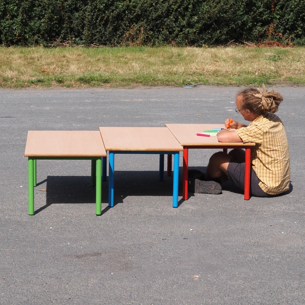 Low school table with wooden laminated table top and colorful lacquered steel legs (H. 46 cm)