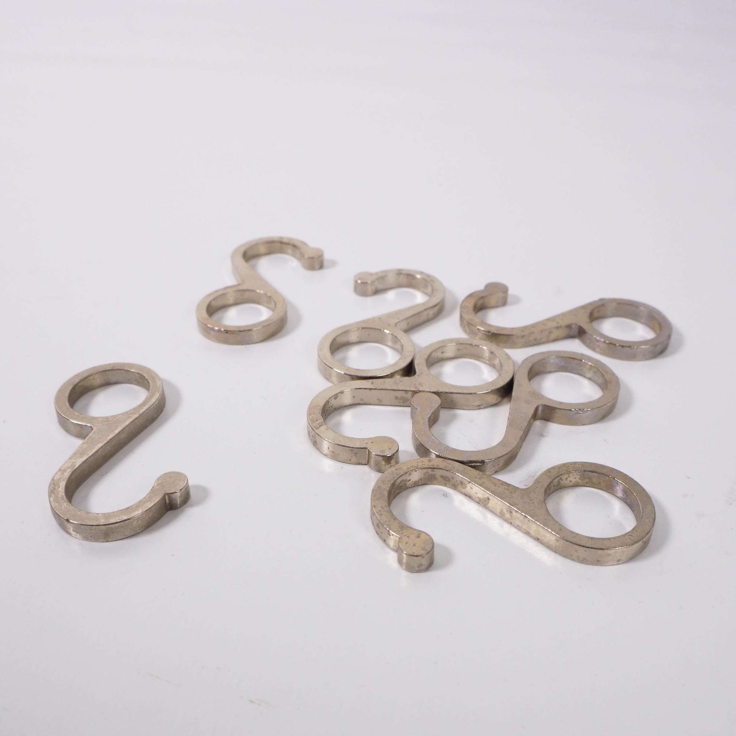 Small rounded cast metal tube hooks