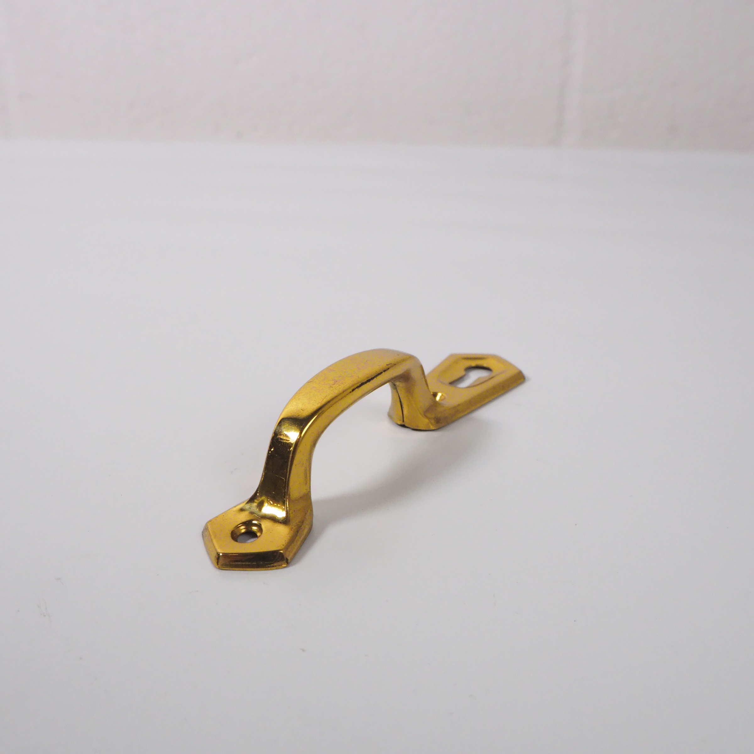 Polished brass cabinet handle with key hole