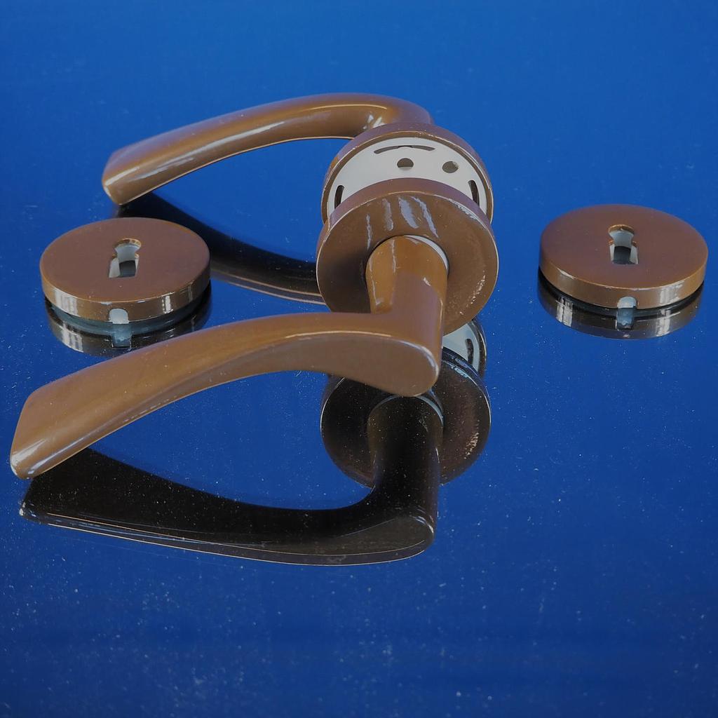 Door handle in brown powder coated steel with key rosettes