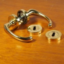 Door handle in brass plated aluminium with key rosettes by Linea Bertomani