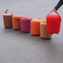 Round ottoman with strap by Satelliet (various colors/finishes)