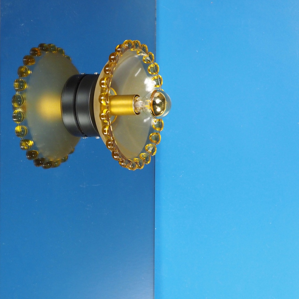 Wall sconce in orange ornate and textured glass