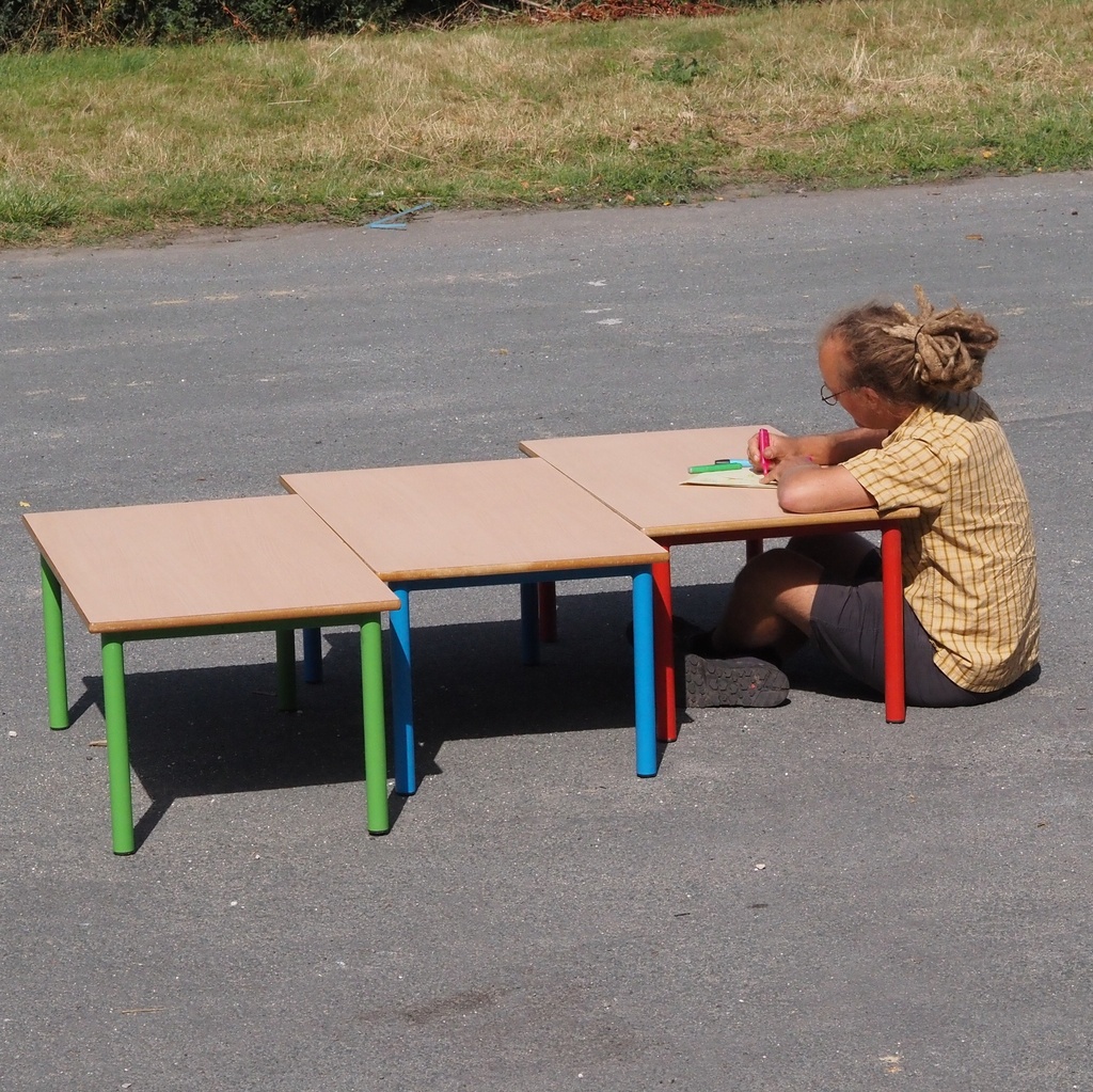 Low school table with wooden laminated table top and colorful lacquered steel legs (H. 46 cm)