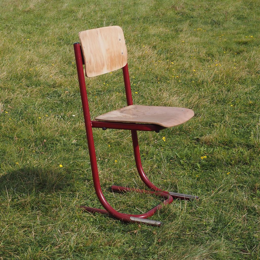 Cantilever chair with plywood seat and powder-coated steel legs