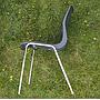 Stackable chair with anthracite polypropylene shell and tubular steel legs