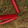 Coat rack in red coated bent steel
