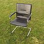 Cantilever armchair in steel and black synthetic leather