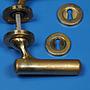Door handle in solid brass with rosettes