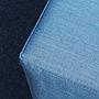 Square ottoman upholstered in grey or blue fabric