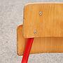 Stackable school chair with red tubular steel legs