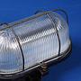 Caged wall/ceiling light with bakelite base, steel cage and textured glass diffuser