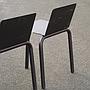 Black stackable chair by Pierre-Emmanuel Vandeputte (with various coloured corners)