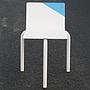 White stackable chair by Pierre-Emmanuel Vandeputte (with various coloured corners)