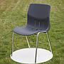 Stackable chair with anthracite polypropylene shell and tubular steel legs